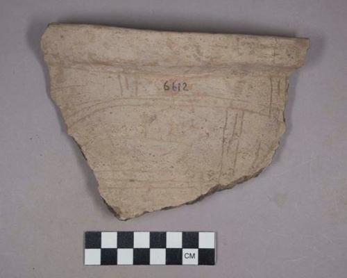 Earthenware rim and body sherd with incised designs