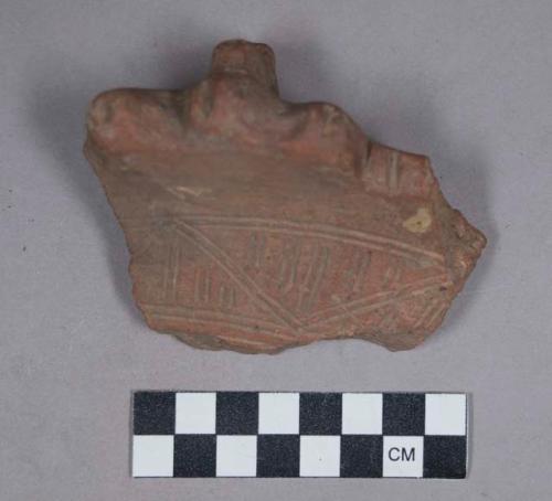 Earthenware vessel sherd with handle, modeled and incised designs