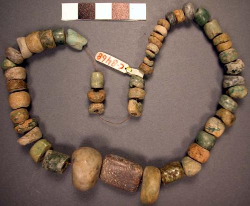 Ground stone; beads; strung together