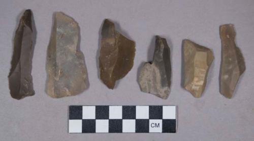 Flint blades and burins, some with cortex, some retouched, some with bulb of percussion