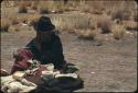 Woman selling items at edge of track