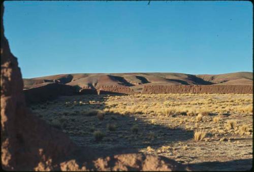 Adobe wall and field in Pillapi