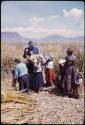 Missionary with children, on floating island (Uros islands)