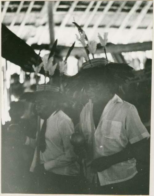 Kantules, with flutes and rattles, singing during chicha fiesta