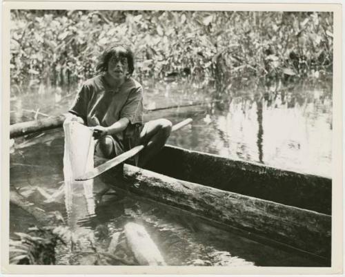 Priest makes holy vestments within canoe