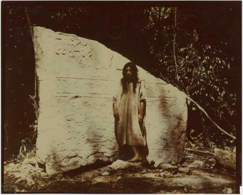 Kayom Carranza standing before Stela 1 fragment