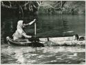 Woman and baby in canoe