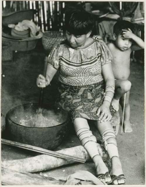 Woman preparing a drink of cooked mashed bananas and cocoa