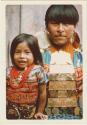 Woman and child in gala dress, displaying gold nose rings, earrings, and gold breastplate