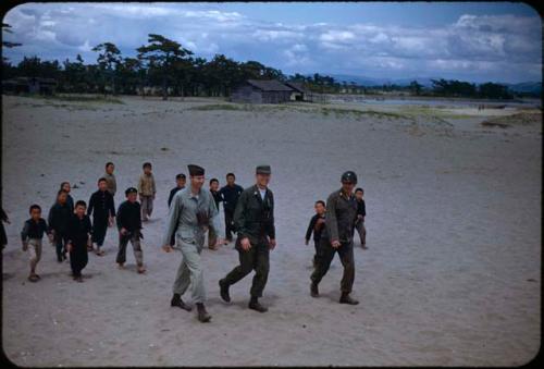 American soldiers and children on beach