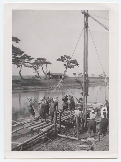 Women using ropes for pile driving