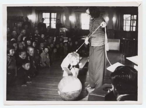 Woman with monkey performing at party for orphans