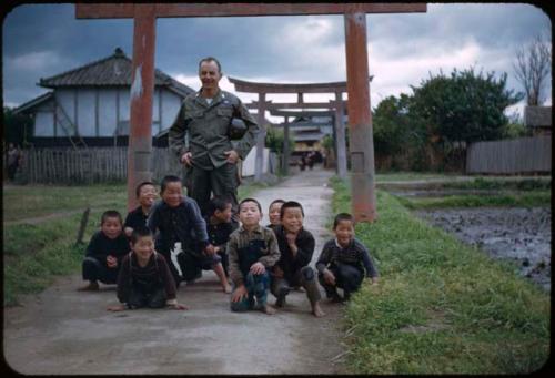 Major Geisert with children, in front of torii