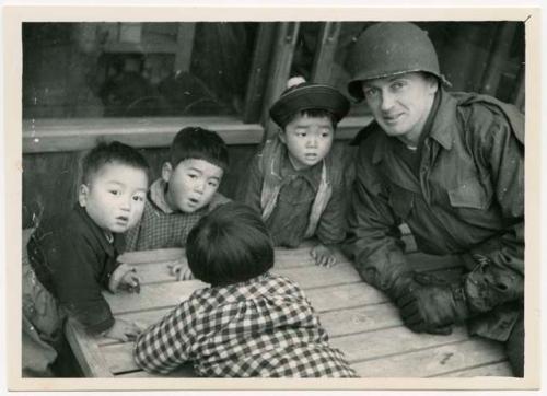 Dispensary assistant Evenson, and group of children