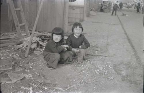 Two children along side of street