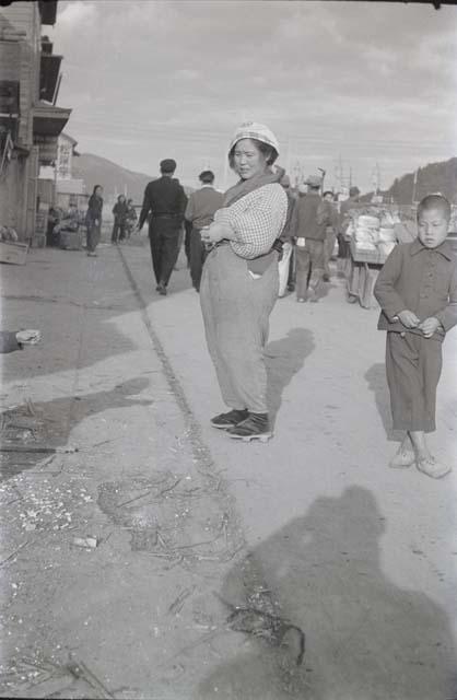 Woman standing along side of street