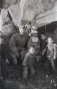 Man with group of children and Buddha statue