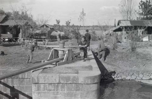 Women opening lock on Kitakami Canal