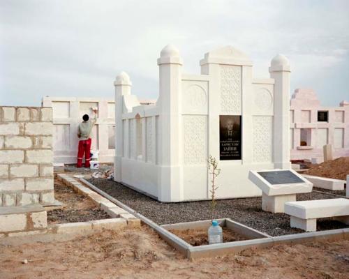 "An Uzbek migrant workers pastes plaster in to the cracks of a mausoleum. When the Koshkar-Ata cemetery was first established, mausoleums were reserved for local saints. Today the most splendid tombs honor local oil barons. Koshkar-Ata, Kazakhstan, 2010"