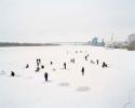 "Fisherman cut holes in the frozen river on the outskirts of the city.  Astrakhan, Russia, 2012"