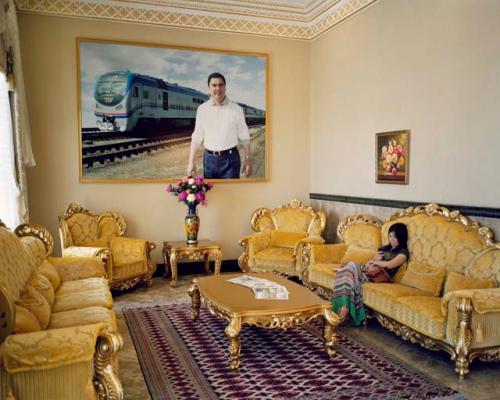 "A larger-than-life-size photograph of Turkmenistan's president, Gurbanguly Berdymukhamedov, towers over a hotel guest. Awaza, Turkmenistan, 2012"