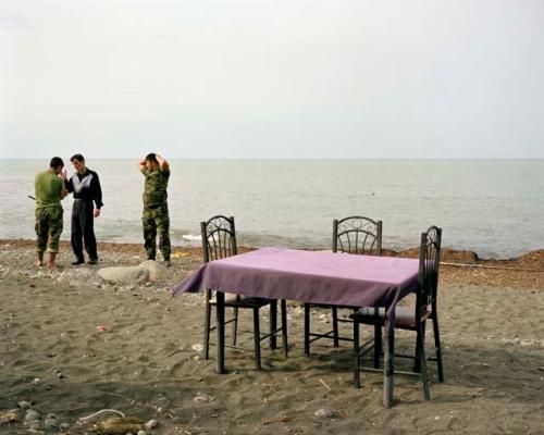 "At a beach cafe, Azerbaijani soldiers question a local man. Lankaran, Azerbaijan, 2010"