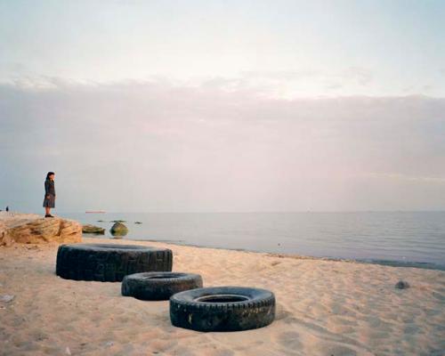 "In the oil boomtown of Aktau, a woman looks out to sea. Aktau, Kazakhstan, 2010"