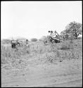 Bulldozer and automobile in clearing