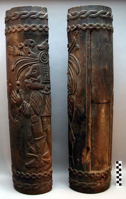 Hollow log split lengthwise and carved with maya-style designs. In two pieces.