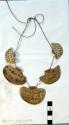 Necklace or string of pendants made of worked bone plates with incised+