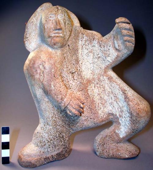 Whale bone carving. Standing male figure, full-round with incised.