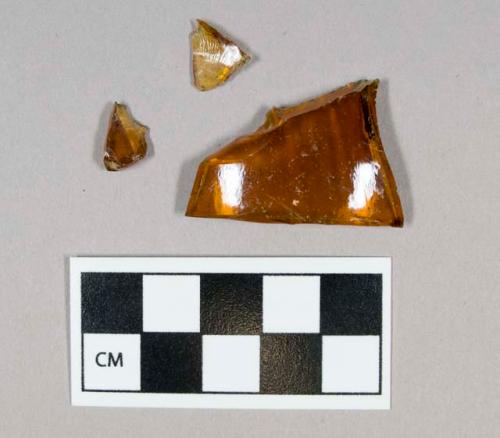 Glass, curved, amber, fragments