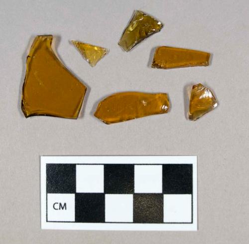 Glass, curved, amber, fragments