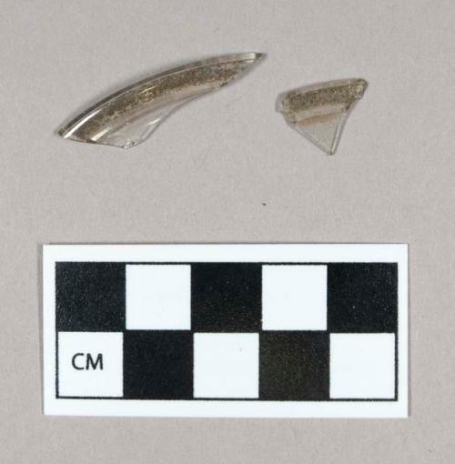 Glass, curved, clear with unknown pigment, partial rim fragments