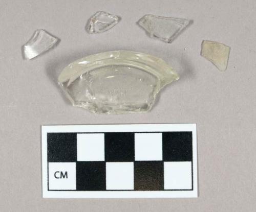 Glass, curved, clear, fragments, one partial bottle base