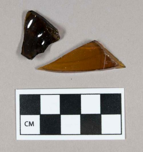 Glass, curved, amber, fragments