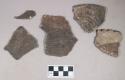 Ceramic, earthenware body sherds, cord-impressed, shell-tempered; ceramic, earthenware rim sherds, one incised with possible Ramie design, one with possible handle attachment and notched rim; three body sherds crossmend