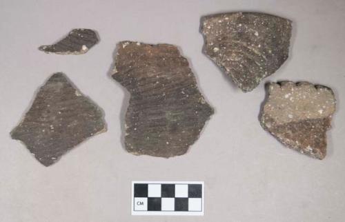Ceramic, earthenware body sherds, cord-impressed, shell-tempered; ceramic, earthenware rim sherds, one incised with possible Ramie design, one with possible handle attachment and notched rim; three body sherds crossmend
