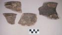 Ceramic, earthenware rim sherds, notched rims, undecorated, shell-tempered, three with fragmented handles