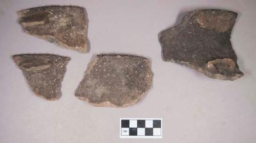 Ceramic, earthenware rim sherds, notched rims, undecorated, shell-tempered, three with fragmented handles