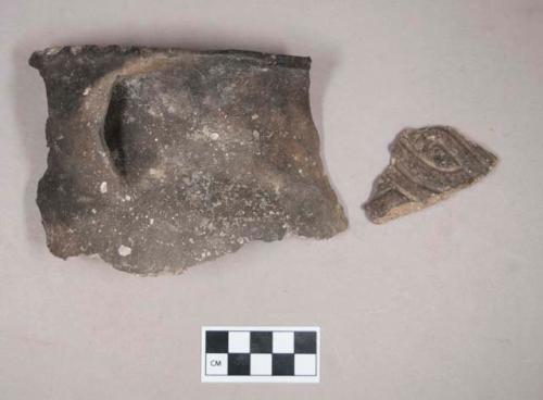 Ceramic, earthenware rim and handle sherd, incised above handle, undecorated body, shell-tempered; ceramic, earthenware body sherd, incised with possible Ramie design, shell-tempered