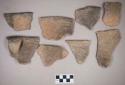 Ceramic, earthenware rim, handle, and body sherds, incised with possible Ramie design, one rim incised, shell-tempered; one rim sherd crossmends with rim and handle sherd; two rim sherds crossmend
