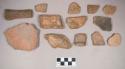 Earthenware vessel rim, body, and foot ring base sherds. Most with red painted interior and exterior. Some with white painted exterior.
