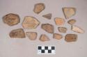 Earthenware vessel rim and body sherds. Most with red painted interior and exterior. Some with white painted exterior and interior. Some with charring.