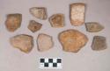 Earthenware vessel rim and body sherds. Most with red painted interior and exterior. Some with white painted exterior and red painted interior.