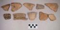 Earthenware vessel rim, body, and foot ring base sherds. Most with red painted interior and exterior. Some with white painted exterior and  interior. Some charred.