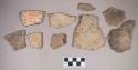 Earthenware vessel rim and body sherds. Most with red painted interior and exterior. Some with white painted exterior and interior. Some with red on buff paint. Some charring.