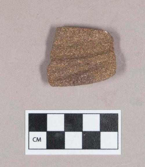 Ground stone, grooved stone fragment, two grooves on one side, possible abrading stone