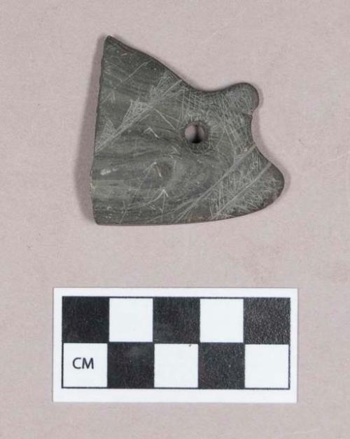 Ground stone, worked stone object fragment, perforated, with incised decoration