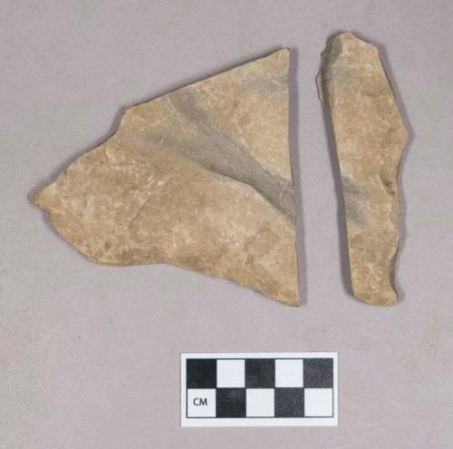 Ground stone, grooved stone fragments, flat, two grooves crossing one another, possible abrading stone; two fragments crossmend